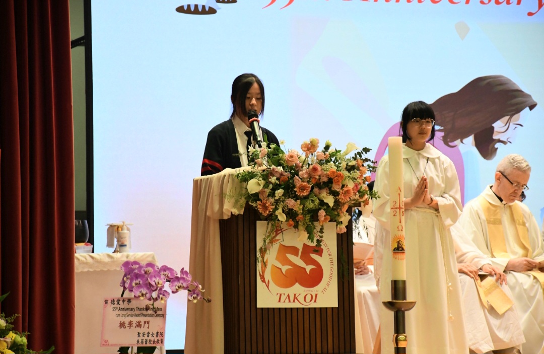 A group of girls wearing masks and standing in front of a statueDescription automatically generated